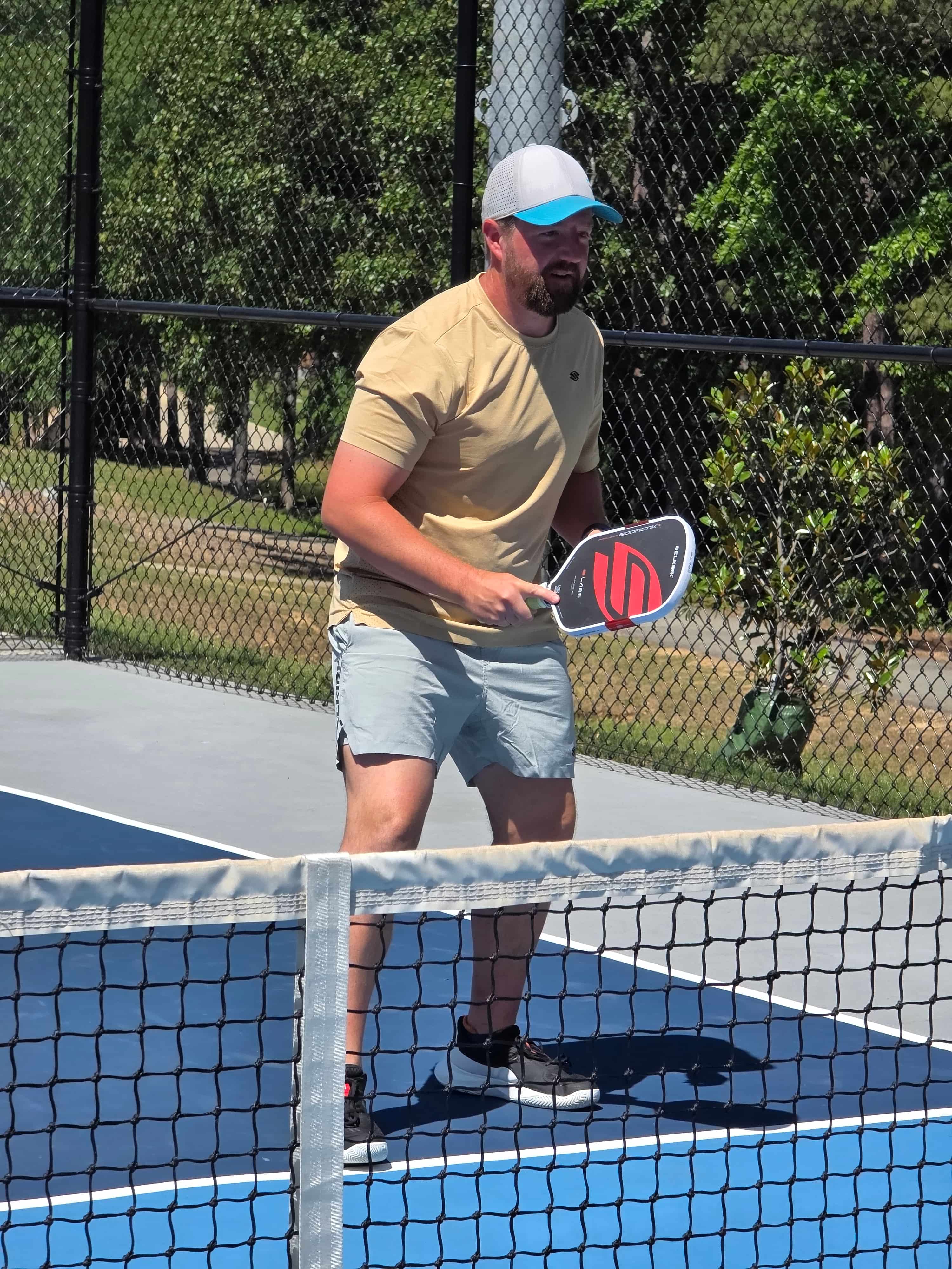 Coach Zac Deem on the pickleball court holding a paddle